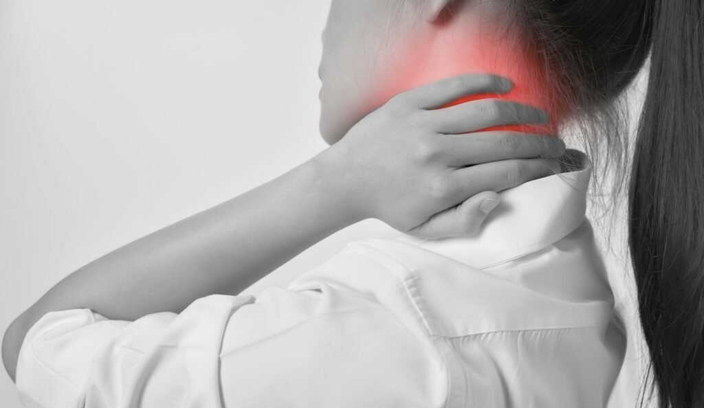 Close-up of Asian women acute pain in a neck, Health care and medical concept. gray background.