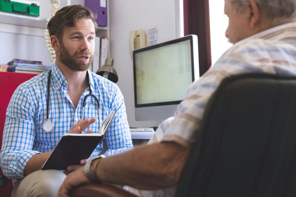 Male doctor prescribing medicament to senior man in clinic room